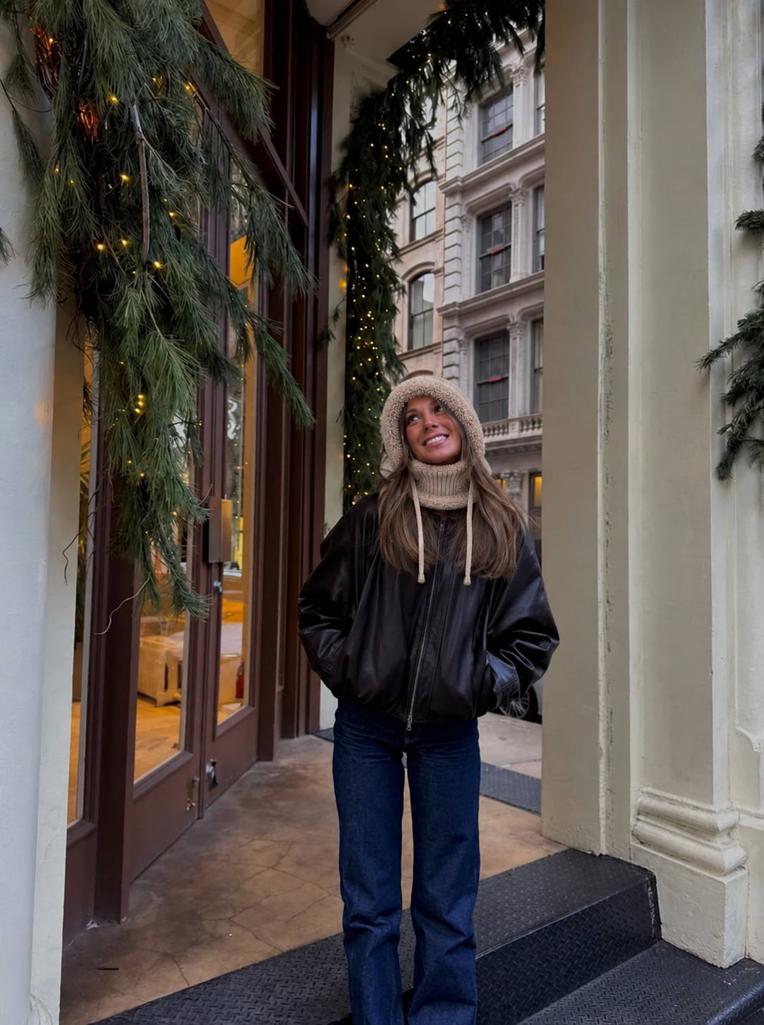 Oat 3-in-1 plush beanie worn with a black leather jacket outside a cafe